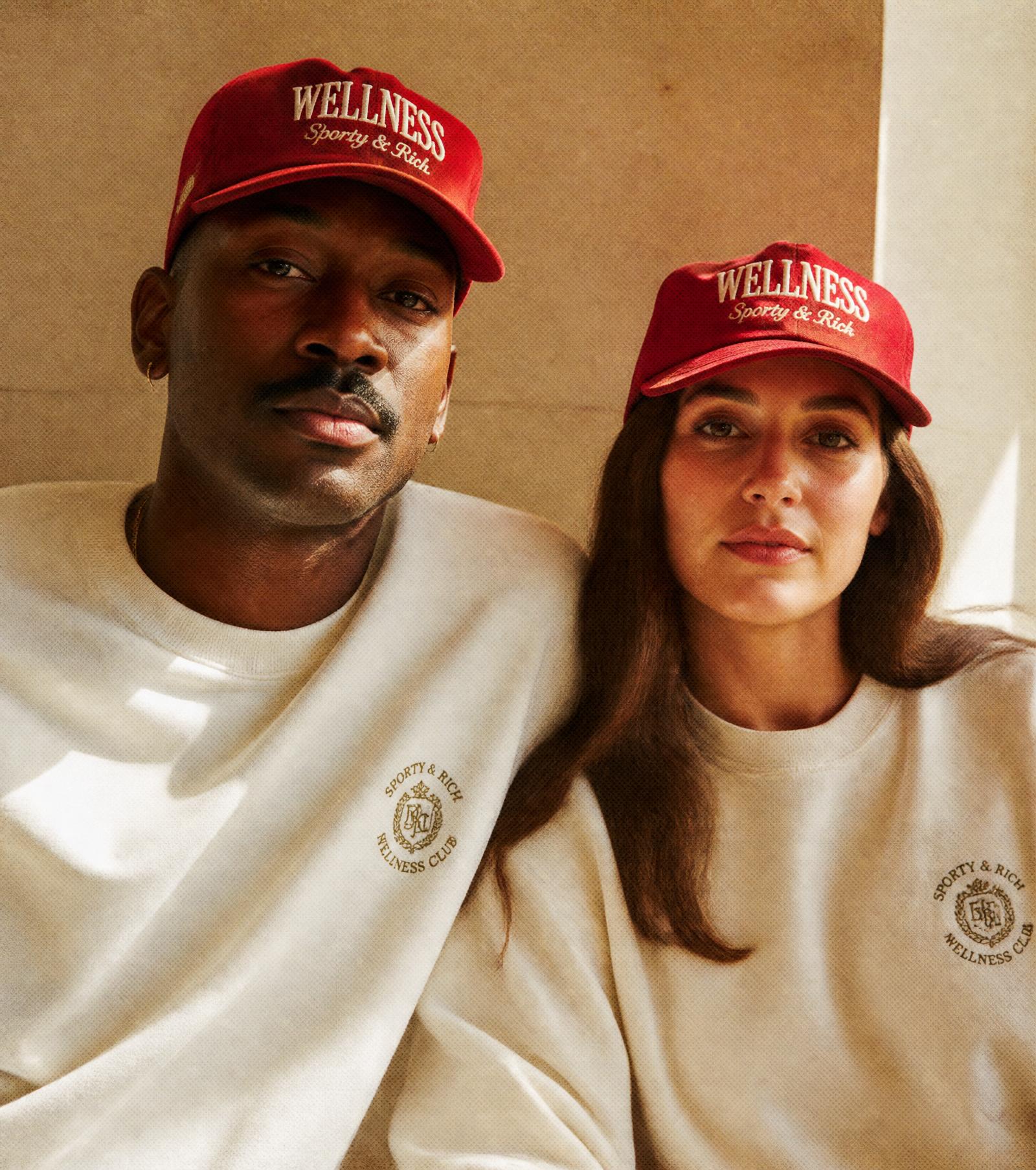 Two people wearing Save Yourself caps